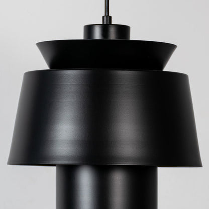 Black metal pendant light featuring layered sculptural form and matte finish showcasing refined modern craftsmanship.