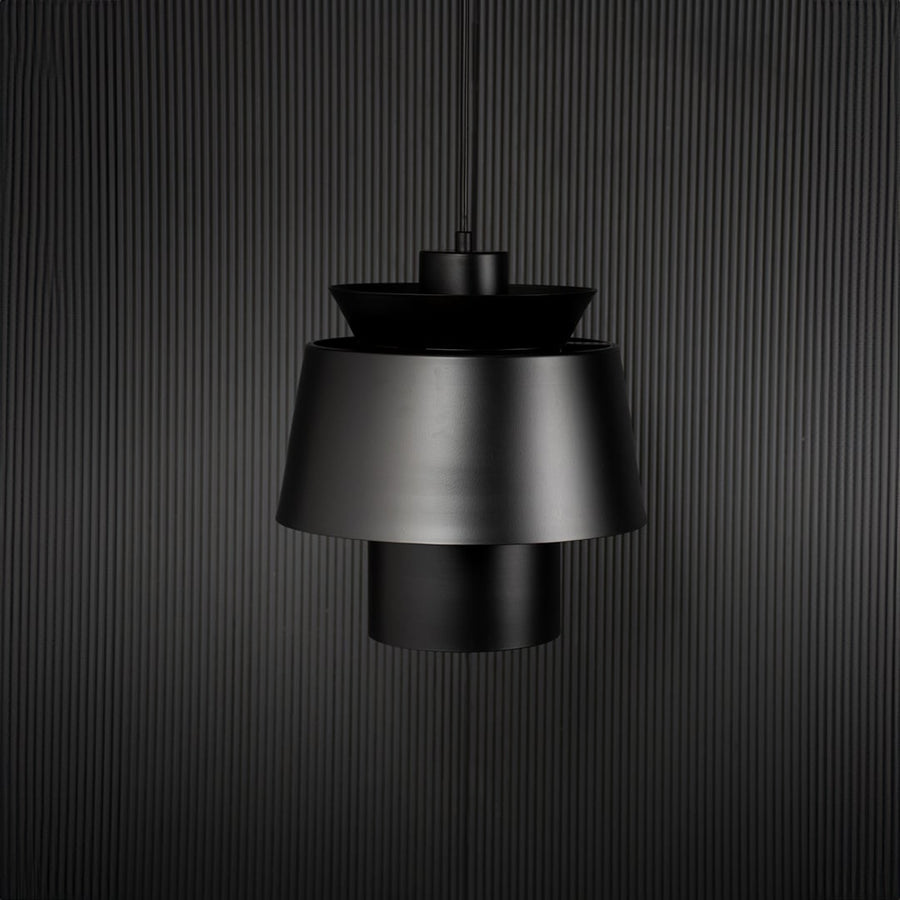 Black metal pendant light with layered shade bringing modern elegance to kitchen ceiling spaces.