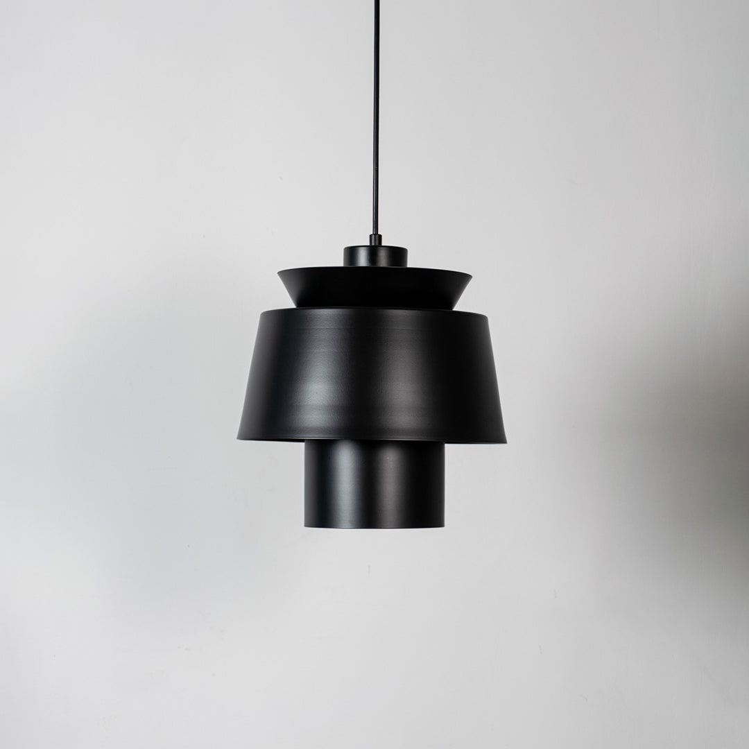 Black metal pendant light with layered geometric design and matte finish for sophisticated contemporary ceiling lighting decor.
