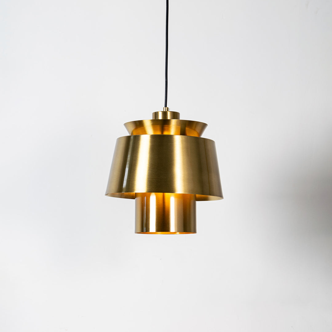 Brass metal pendant light with layered geometric design and brushed finish for sophisticated ceiling lighting decor.