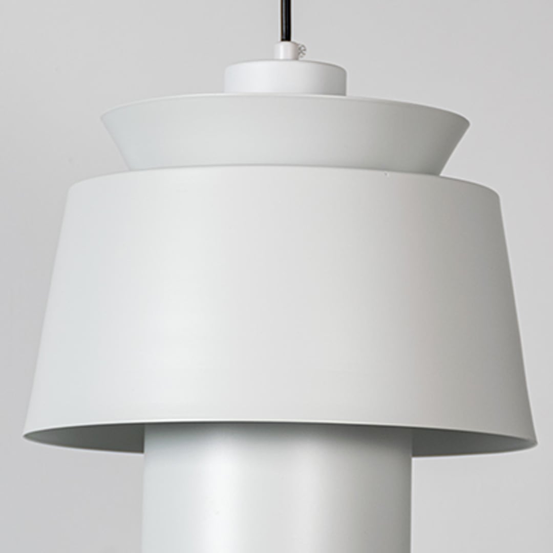 A closeup view of a modern pendant lamp focusing on its layered shade structure and refined detailing for a clear look at its craftsmanship.
