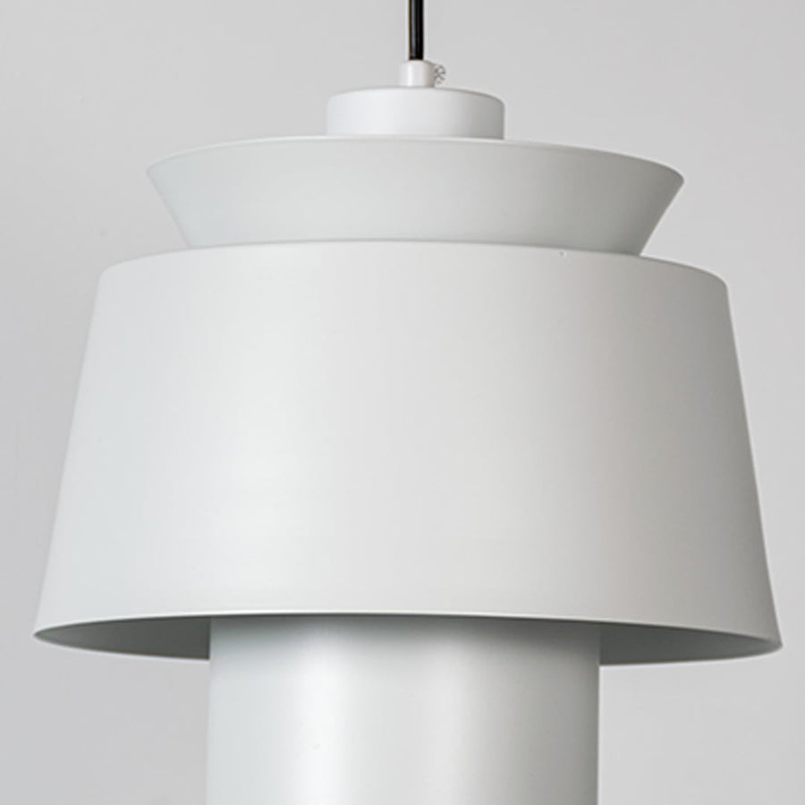 A closeup view of a modern pendant lamp focusing on its layered shade structure and refined detailing for a clear look at its craftsmanship.