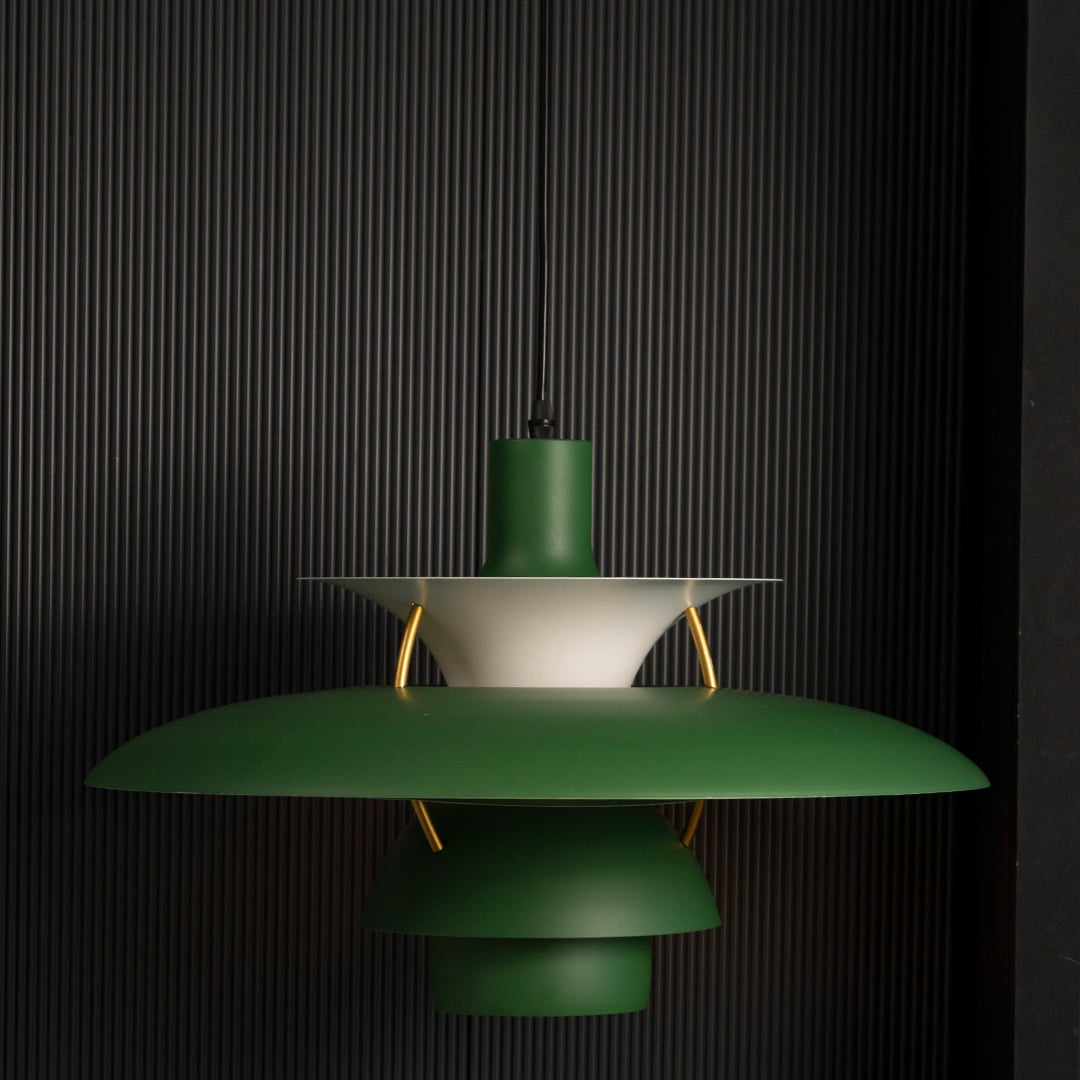 Green PH5 inspired metal pendant light displayed on black background showcasing smooth finish layered form and modern ceiling lighting appeal.