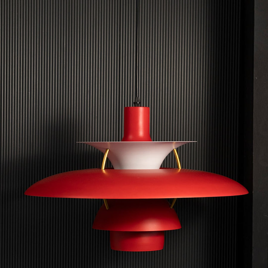 PH5 inspired metal pendant light displayed on black background showing layered shade design soft glow and elegant ceiling lighting for interiors.