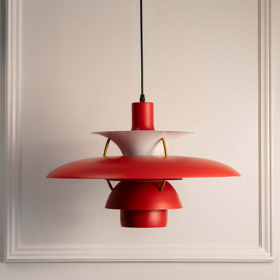 Red metal layered pendant light with smooth finish crafted for modern dining and living spaces.