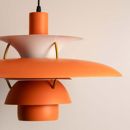 Detailed view of peach orange metal pendant light highlighting refined curves and elegant design.
