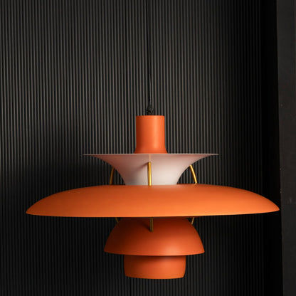 Orange PH5 inspired metal pendant light on black background highlighting vibrant finish balanced illumination and stylish hanging ceiling decor.