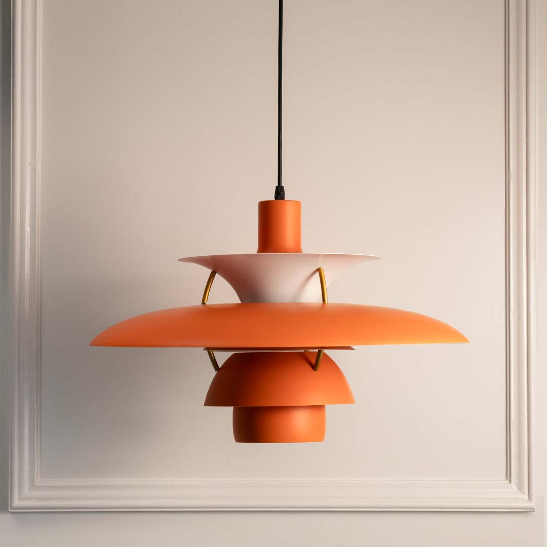Peach orange metal layered pendant light with smooth finish designed for contemporary interiors.