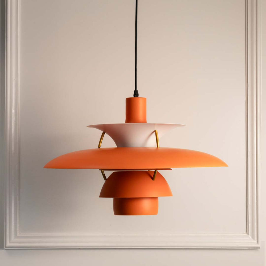 Peach orange metal layered pendant light with smooth finish designed for contemporary interiors.
