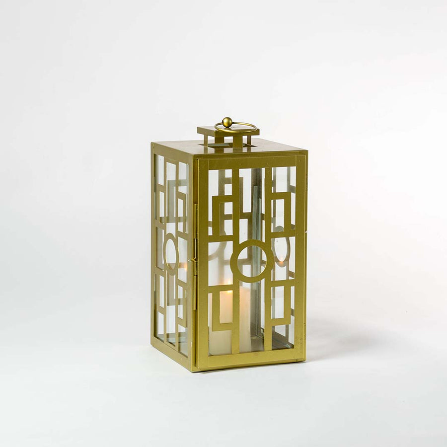 Stylish gold lantern glowing against a dark white background highlighting its elegant metallic finish and intricate geometric grid pattern.