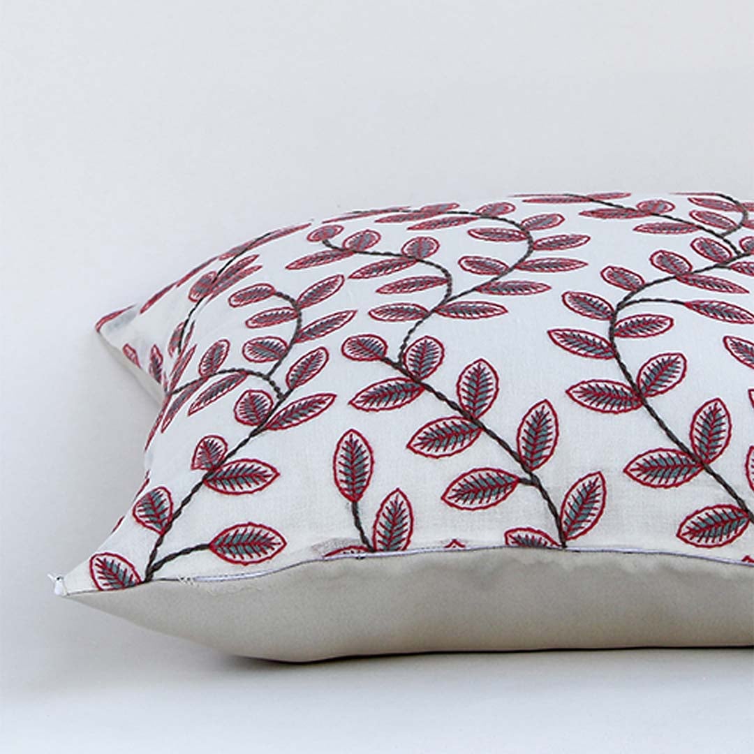 Soft cotton cushion cover with maroon botanical design displayed in a rectangular shape offering a nature inspired home décor look with a smooth breathable and skin friendly feel.