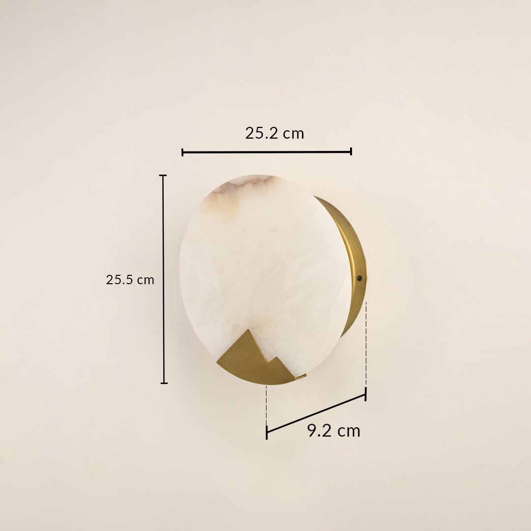Designer marble wall light measuring 25 cm with brass detailing ideal for modern interiors needing warm ambient wall illumination.