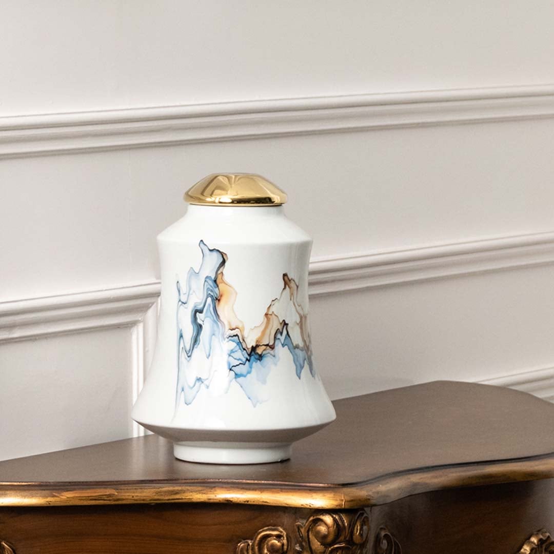 White ceramic jar with blue mountain and horse artwork in a front view ideal for classic décor styling and decorative console use.