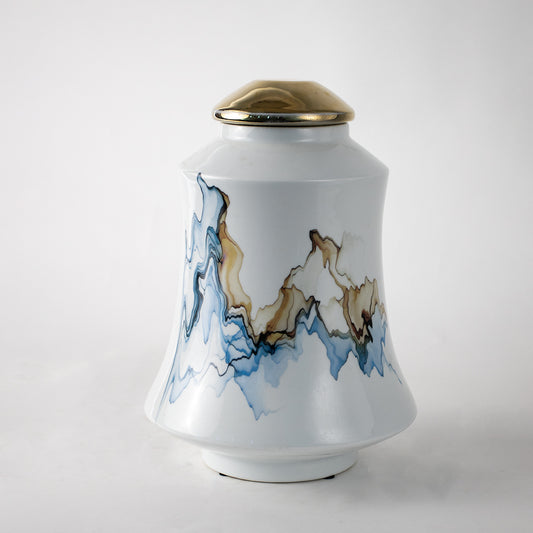 White ceramic decorative jar with blue wave artwork and gold lid for elegant tabletop styling and modern home decor.