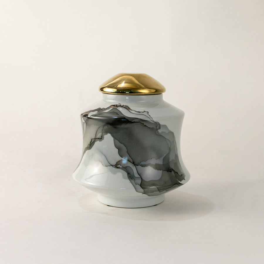 White marble ceramic decorative jar with gold lid for elegant tabletop styling and contemporary home decor displays.