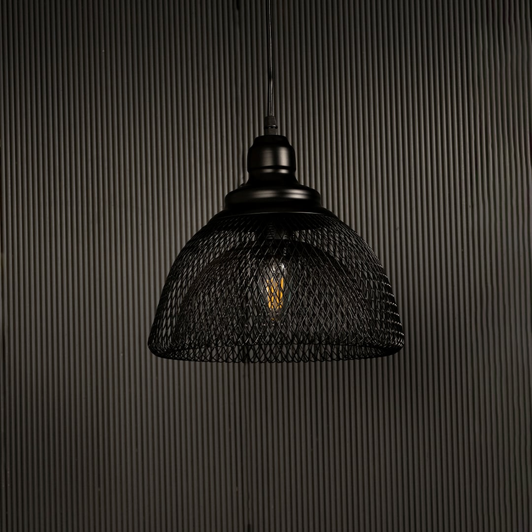Modern industrial black mesh pendant light displayed on dark background with lights off showing contemporary artistic design.