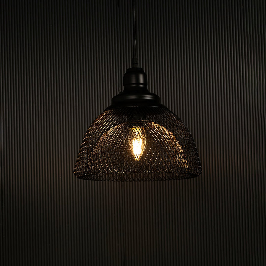 Elegant black mesh pendant light illuminated against dark background highlighting artistic industrial style and fine craftsmanship.