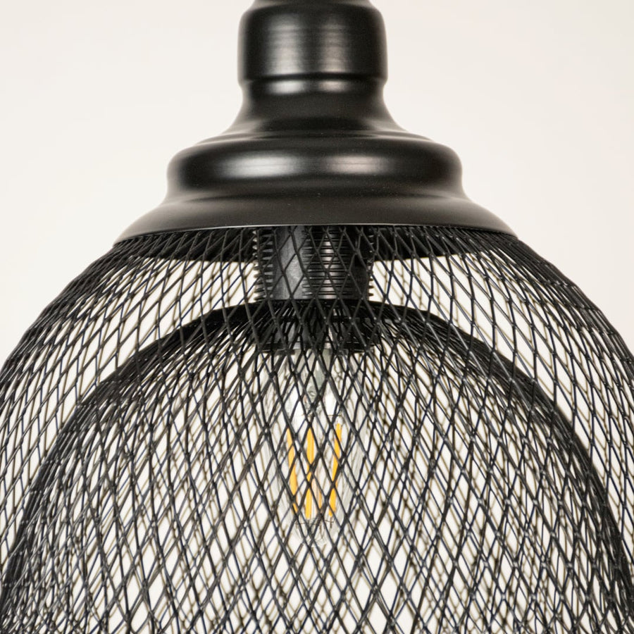 Black metal mesh pendant light closeup highlighting intricate wire detailing and premium industrial lighting craftsmanship.