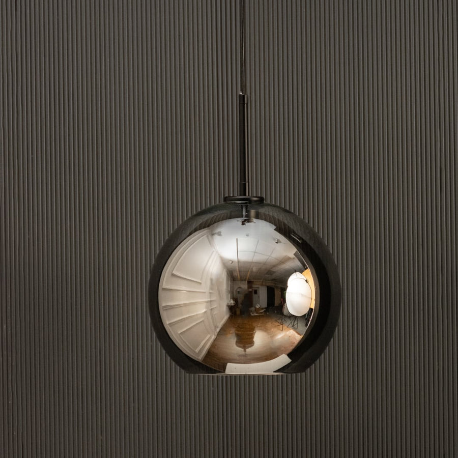 Smoked glass globe pendant light with black suspension sleek modern ceiling lamp perfect for dining and luxury living interiors.