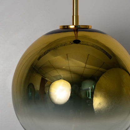 Closeup of golden glass pendant light with sphere design modern ceiling lamp for luxury home interiors and stylish room lighting.