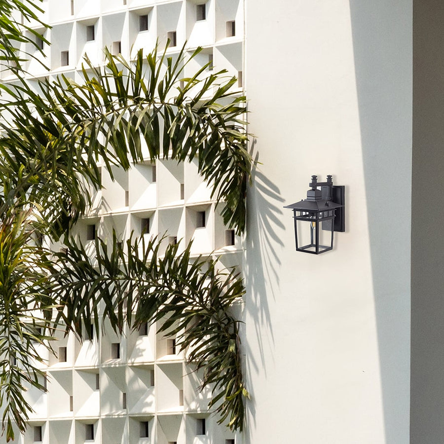 Stylish outdoor wall lantern mounted on house wall enhancing exterior ambiance with warm glow.