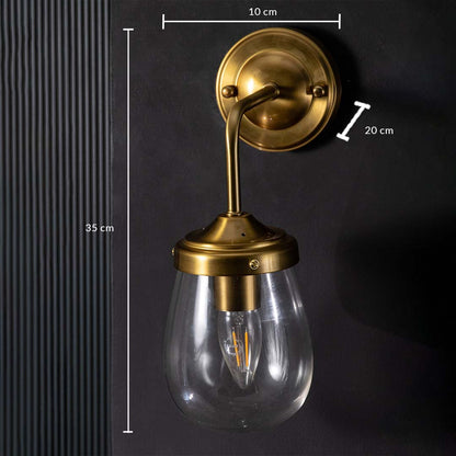 Gold wall sconce with clear teardrop glass shade shown with dimensions measuring 35 cm height 20 cm depth and 10 cm canopy width.