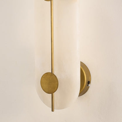 Closeup of white marble and gold metal wall light for premium bedroom and modern decor styling spaces.