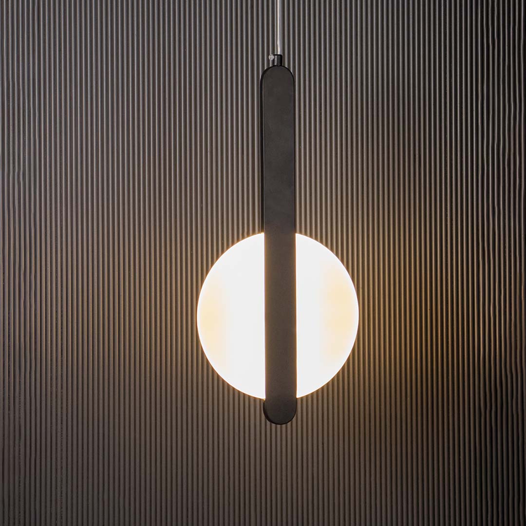 Black and white geometric LED pendant light glowing on black background ideal for stylish dining and living spaces.