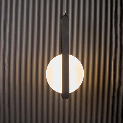 Black and white geometric LED pendant light glowing on black background ideal for stylish dining and living spaces.