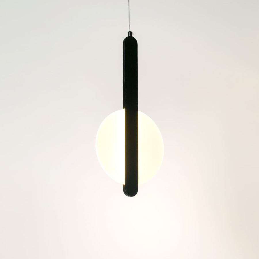 Modern geometric LED pendant light with black bar and white shade illuminated on white background for interiors.