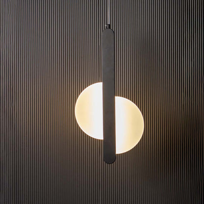 Modern black LED pendant light with vertical bar and frosted circular shade glowing on black background for interiors.