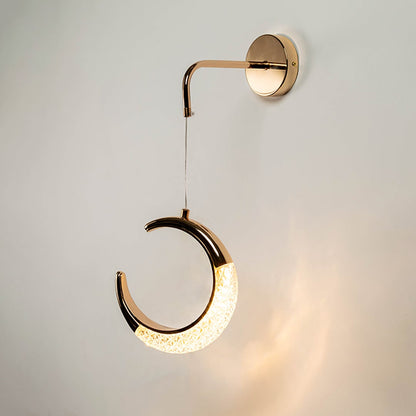 Golden crescent moon pendant light with crystal detail displayed on white background for interiors.