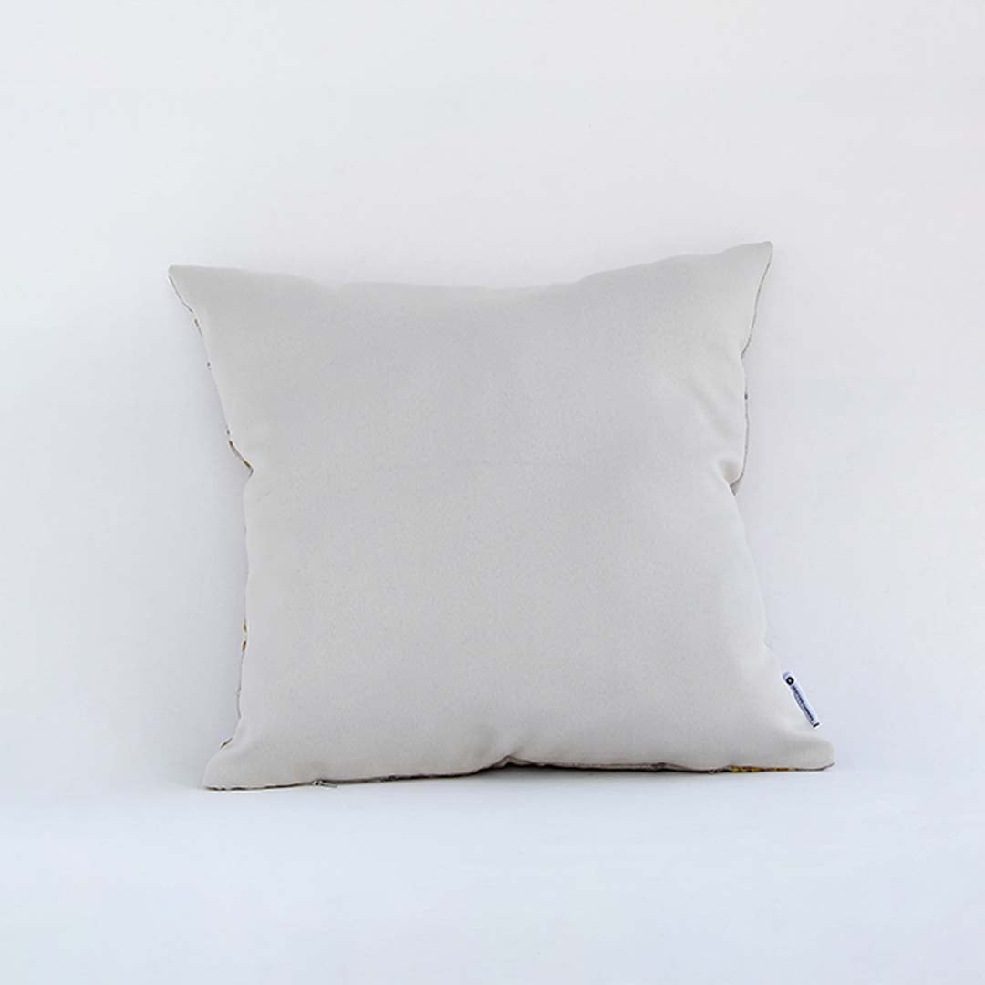 Back side view of white botanical cushion cover showing neat stitching smooth fabric finish and concealed closure.