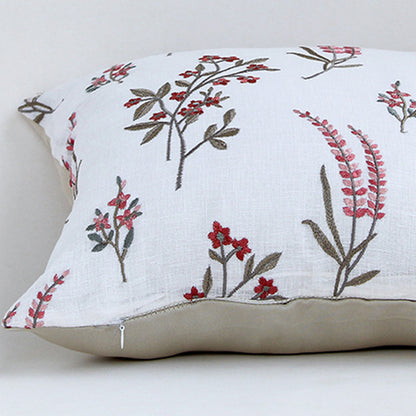 White cotton cushion cover with red floral botanical print highlighting soft cotton fabric and concealed zipper finish.