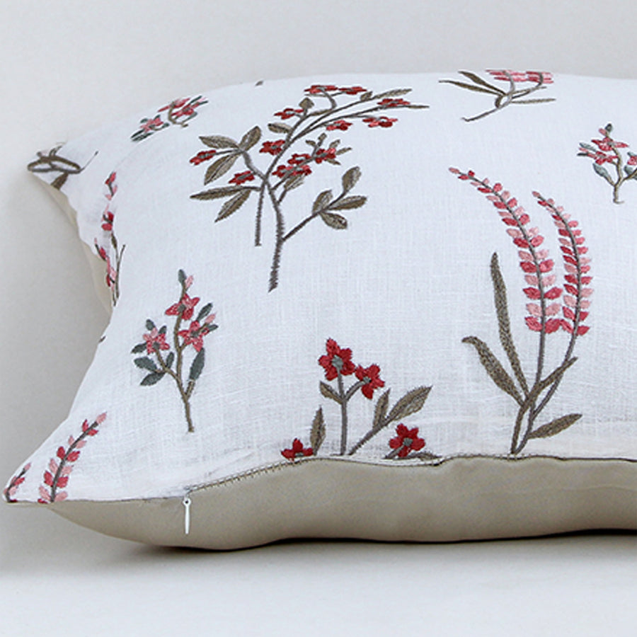 White cotton cushion cover with red floral botanical print highlighting soft cotton fabric and concealed zipper finish.