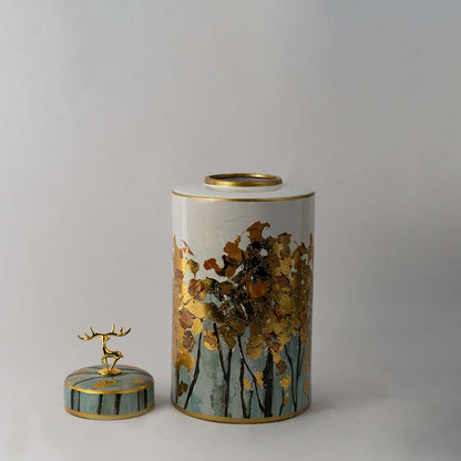 Round ceramic jar with teal lid and gold deer top featuring hand painted golden tree design for elegant home decor
