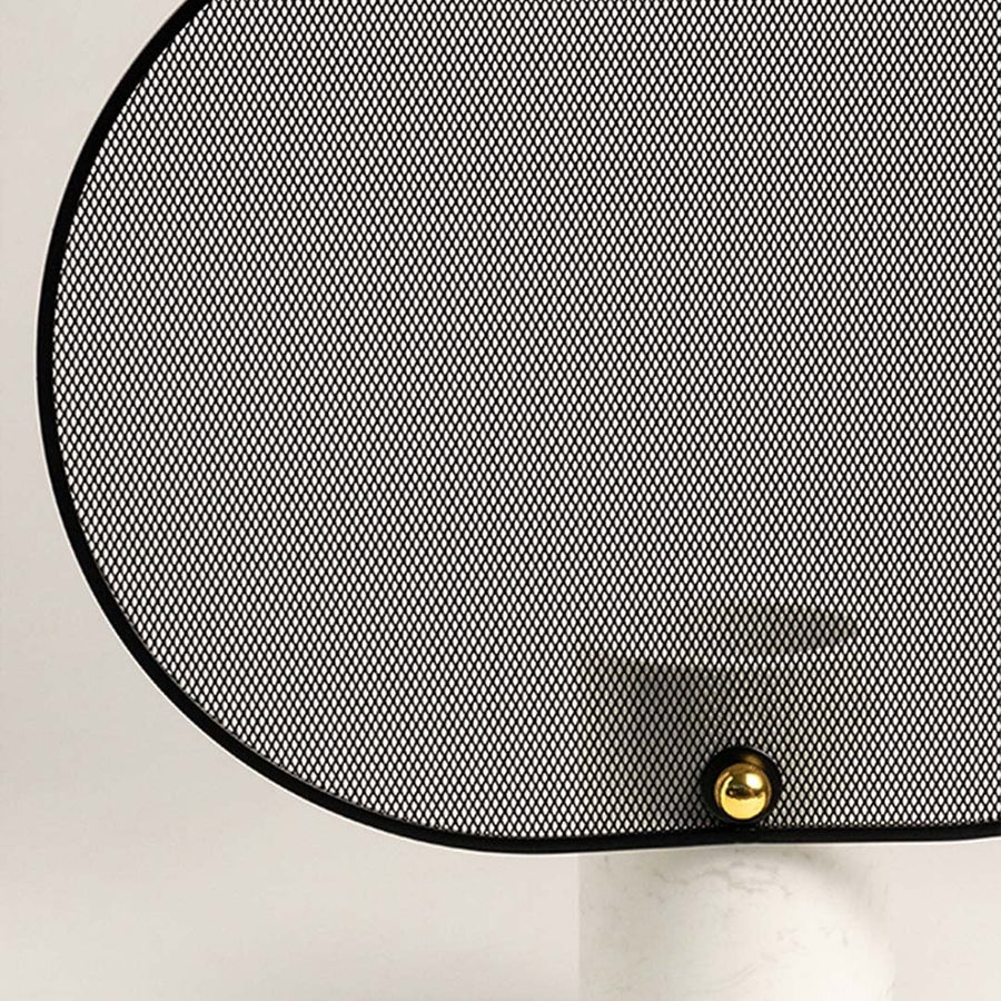 Detailed closeup of black mesh oval screen with gold accent and marble cylindrical base.