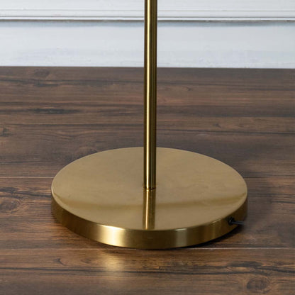 Closeup of gold metal table lamp stand and round base showcasing brushed finish solid construction and elegant modern craftsmanship.