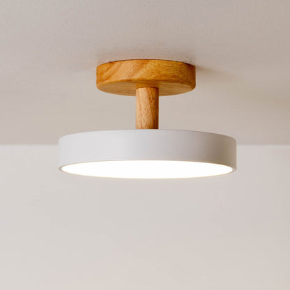 Closeup of white metal and natural wood ceiling light for Scandinavian interior and modern decor styling spaces.