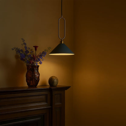Blue conical pendant ceiling light with gold frame glowing warmly above kitchen counter creating modern lifestyle atmosphere.