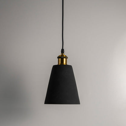 Black cone pendant light turned off with brass accent against plain white background showcasing simple elegant design.