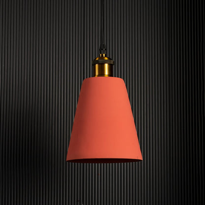 Terracotta cone pendant lamp turned off against a dark background emphasizing its elegant color and warm lighting.