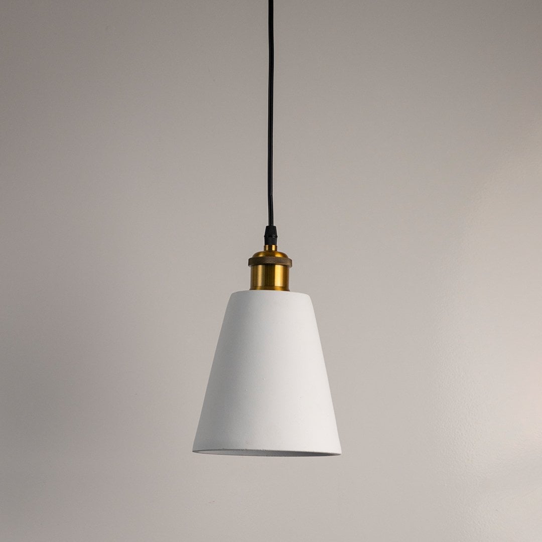 White cone pendant light turned off with smooth matte texture and brass accent displayed against a white background.