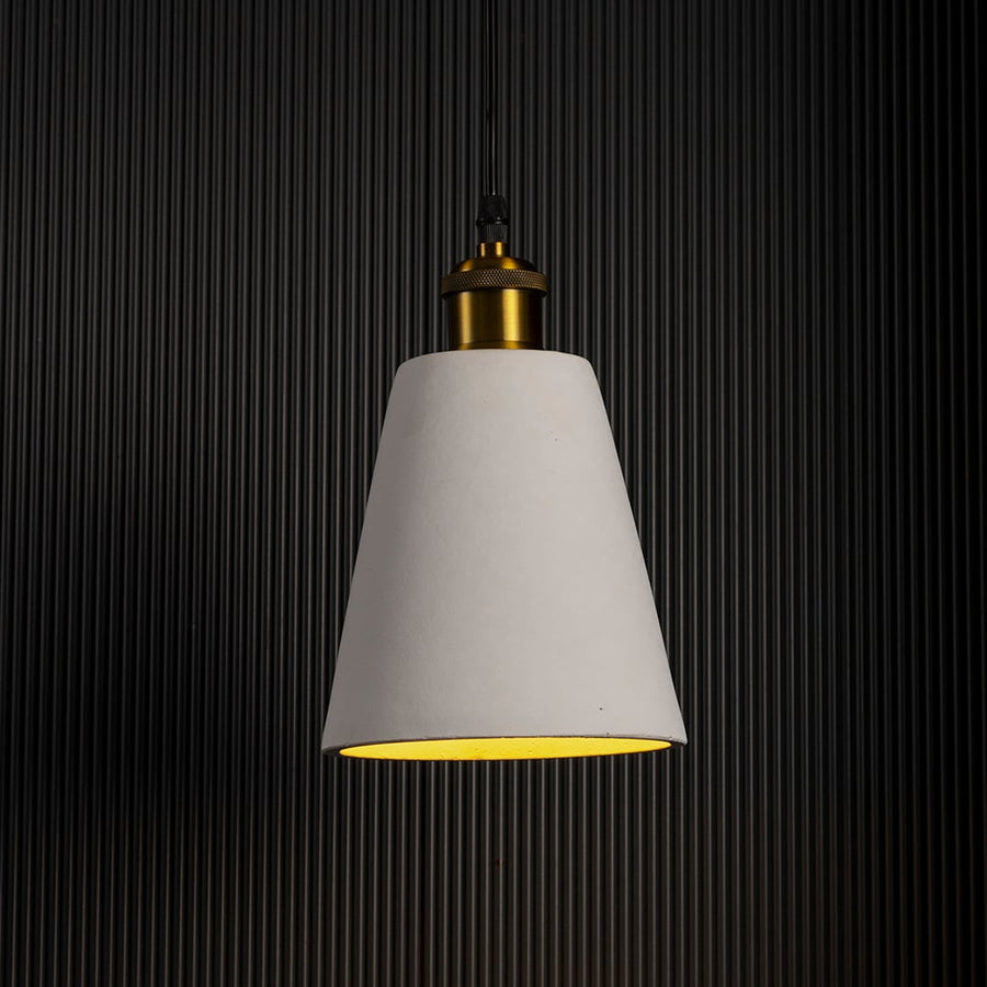 White cone pendant lamp glowing softly against a dark background highlighting its refined silhouette.