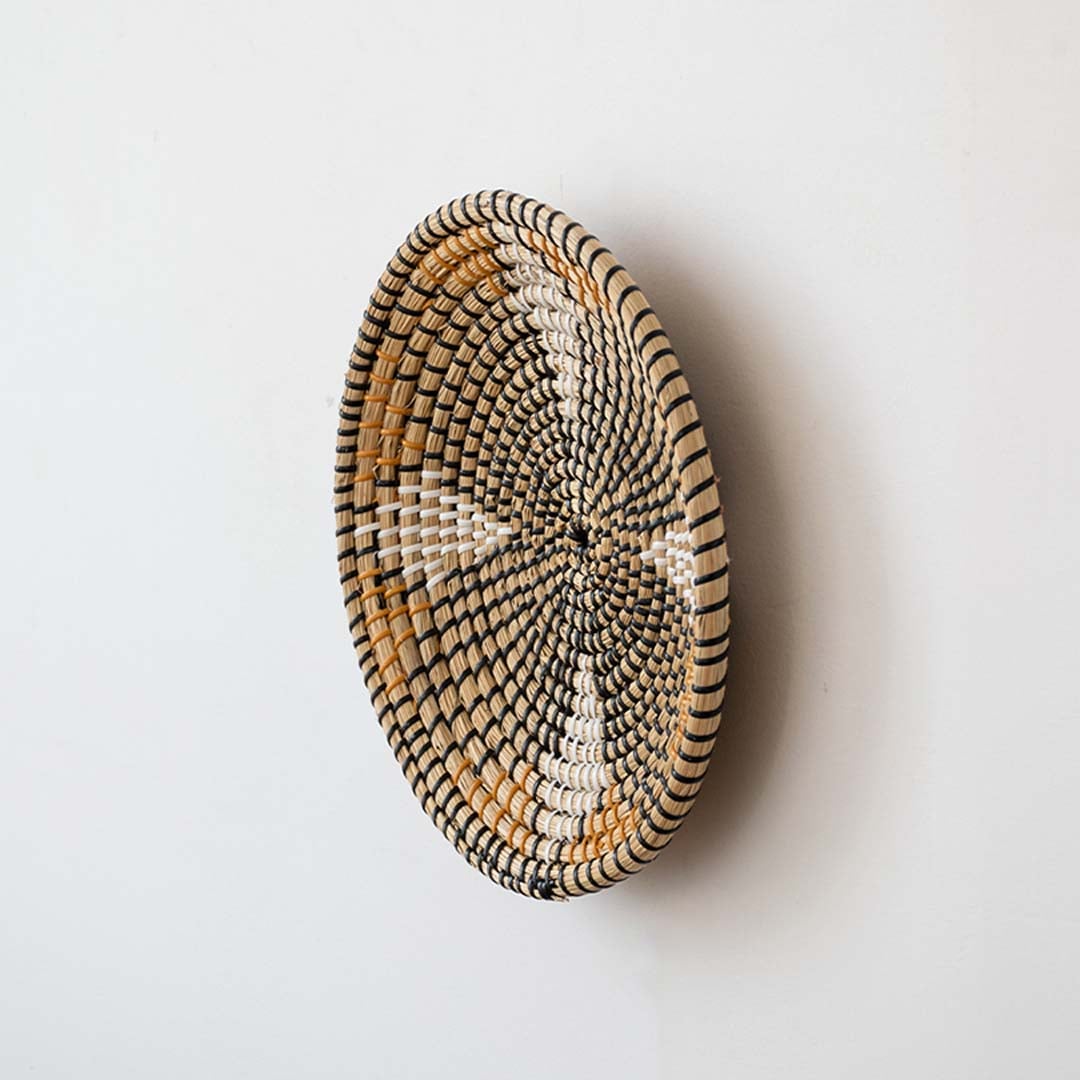 Side profile of wicker wall plate showing natural depth and handwoven texture as eco-friendly decorative basket wall art.