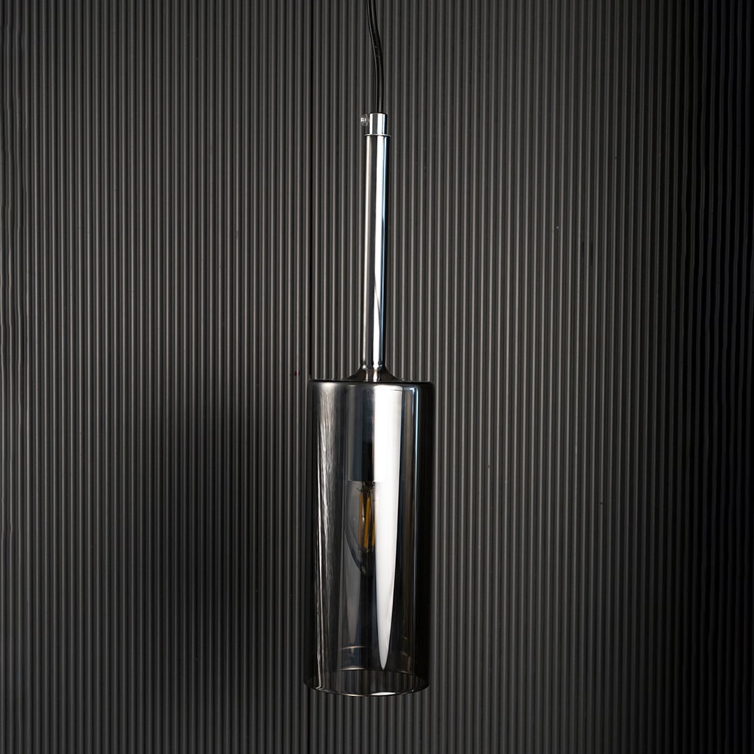 Chrome pendant light turned off against dark background showcasing its smooth reflective surface and sleek design.