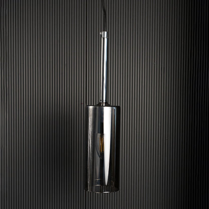 Chrome pendant light turned off against dark background showcasing its smooth reflective surface and sleek design.