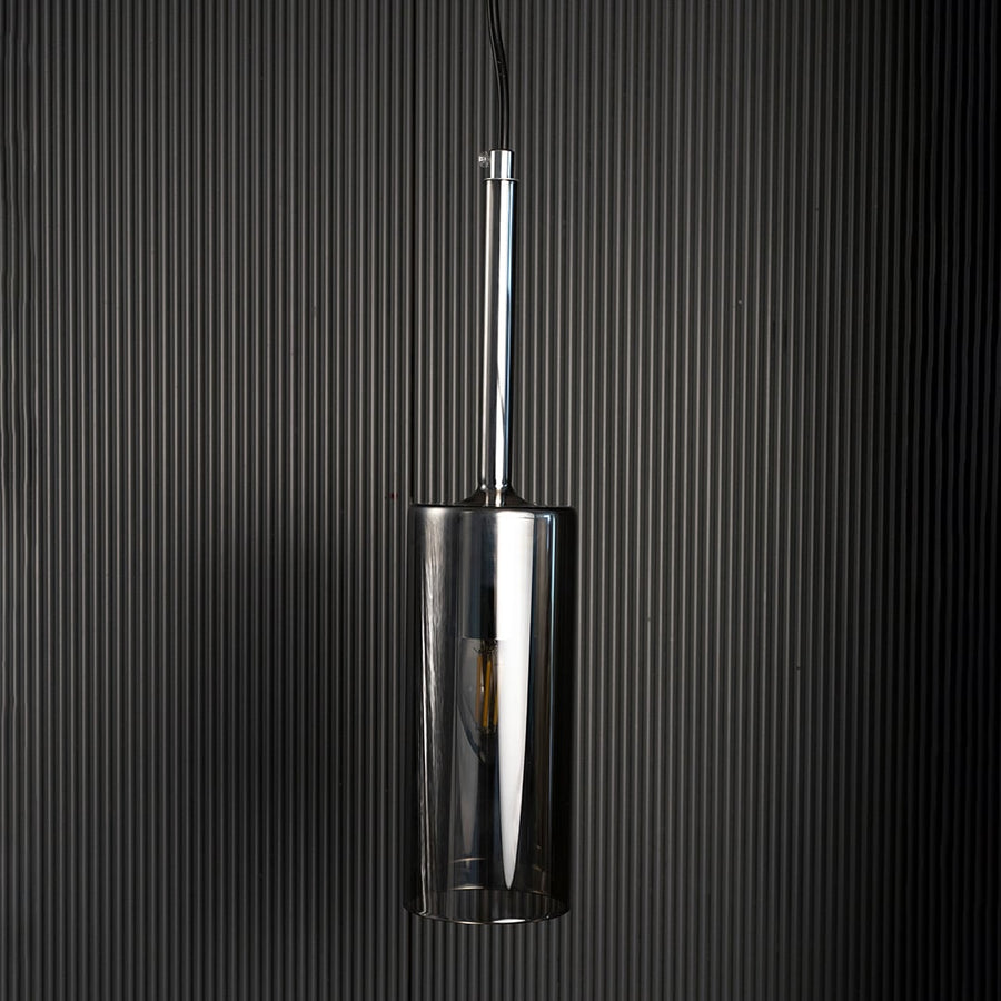 Chrome pendant light turned off against dark background showcasing its smooth reflective surface and sleek design.