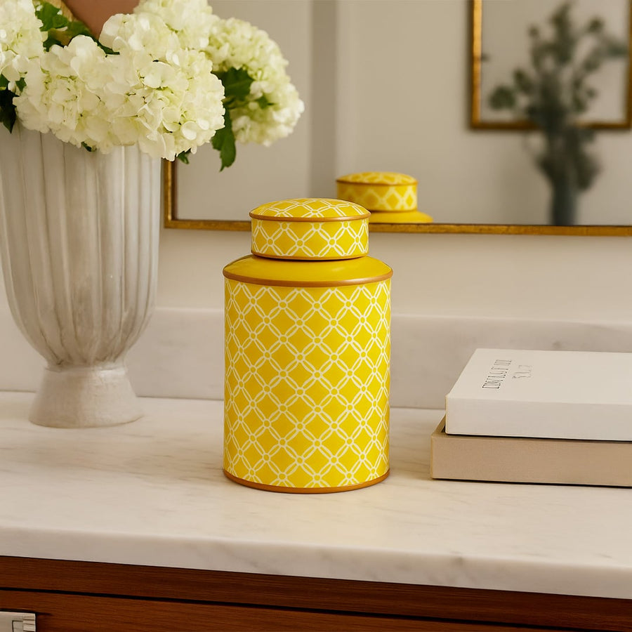 Yellow ceramic jar with white lattice pattern styled on marble countertop for luxury kitchen and home interiors.