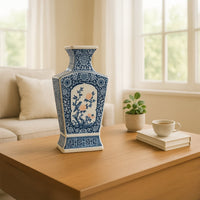 Blue and white ceramic decorative vase displayed on a wooden table for elegant contemporary home decor settings.